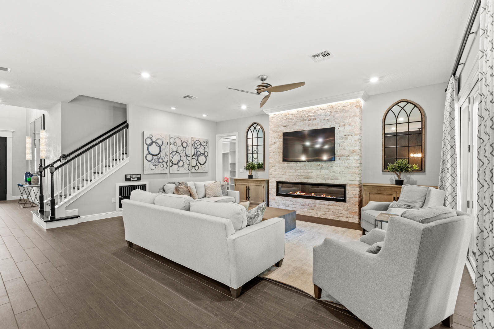 living room with tv and light couches